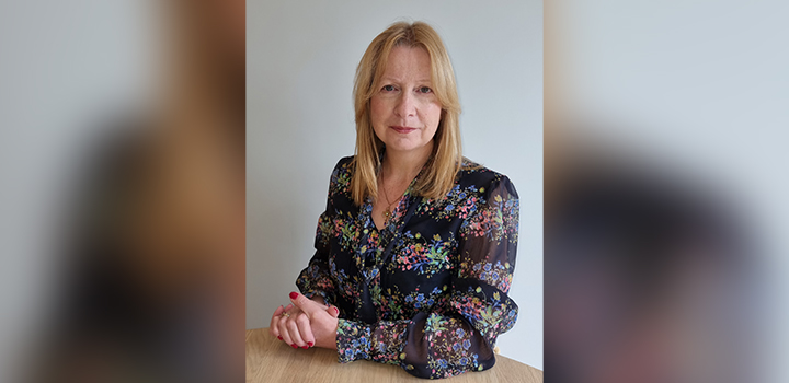Professor Olga Tregaskis sitting at a table