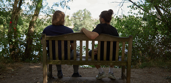 2 people sitting on a bench by the Broad