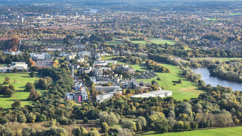 Aerial image taken of the UEA campus, green landscape surrounding the campus