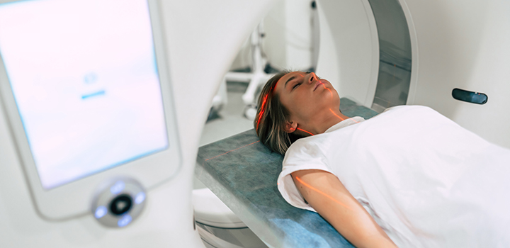 A woman entering an MRI machine.