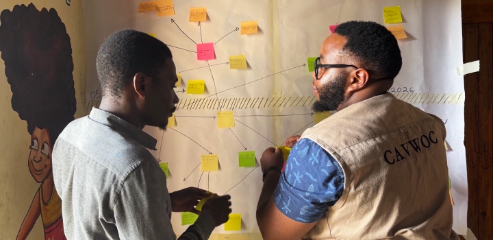 Two participants, discuss intervention outcomes using a Ripple Effects Mapping (REM) technique. © Robert Jere