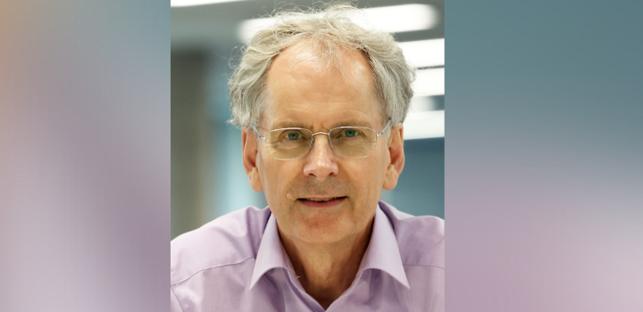 Prof Nick Pidgeon smiling at the camera, he is wearing a lilac shirt and glasses