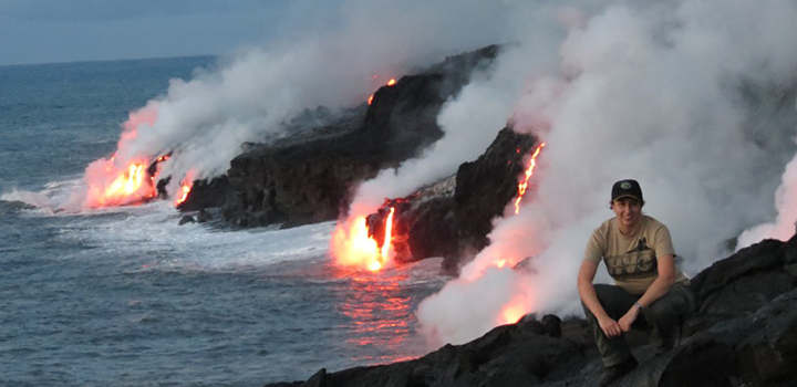 A woman with lava flows in the distance
