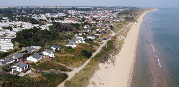 Aerial view of coastal erosion at Hemsby seaside village and beach in Norfolk, England
