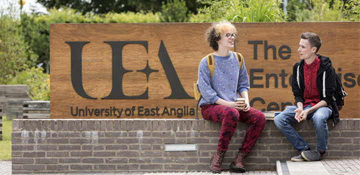 Two people sat on a wall