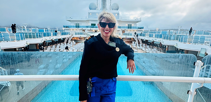 Raubina Kauser standing on a cruise ship in nursing uniform