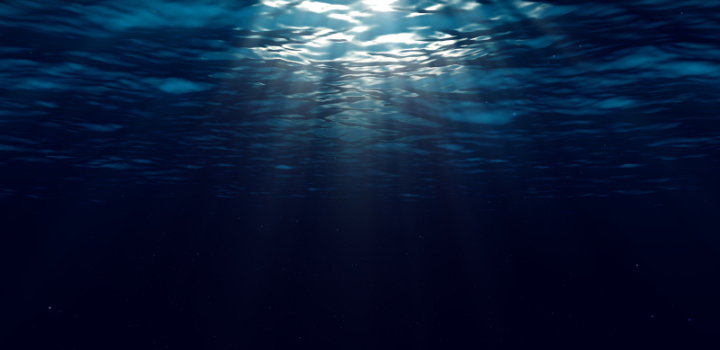 An image of sun breaking through the top of the ocean