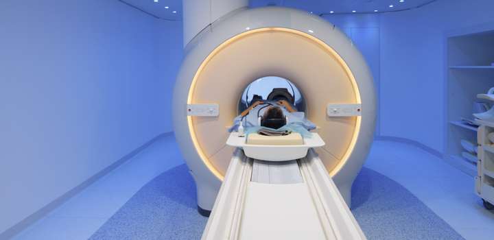 A male patient inside an MRI scanner.
