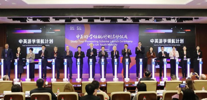 A photo of a line of people standing behind podiums at a launch ceremony