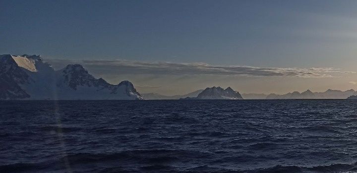 Southern Ocean in Antarctica with snow covered mountains in the background