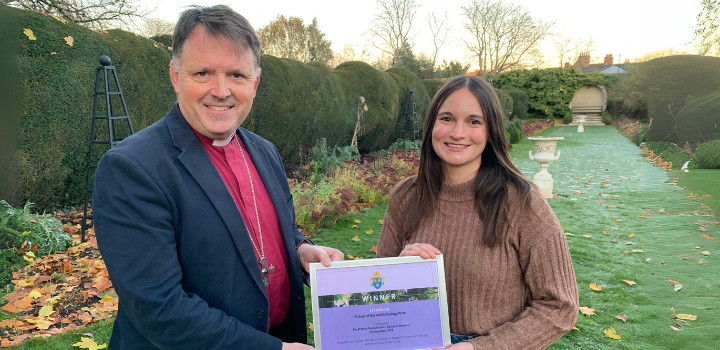 Two people holding a certificate between them