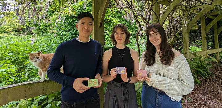 L-R: Sylvester the campus cat, Conrad Yip, Natalie Chabot and Katherine O'Connor with some of the handmade soaps
