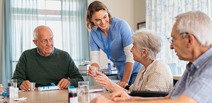 A nurse hands out medicine in a care home.
