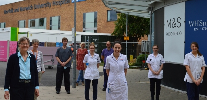 UEA researchers and health workers standing outside Norfolk and Norwich University Hospital