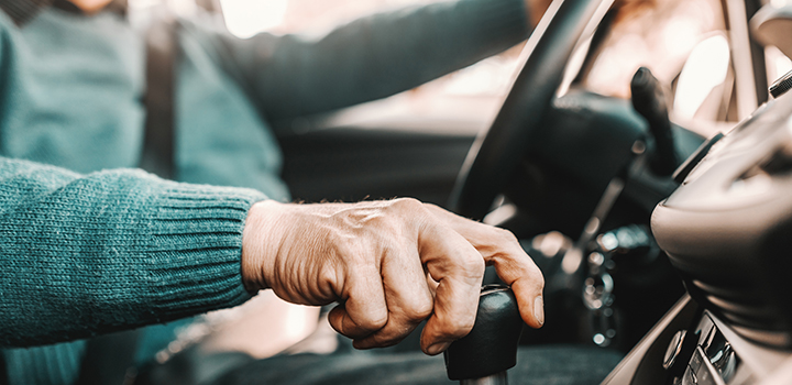 An older man driving.