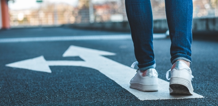 person walking on arrows on road
