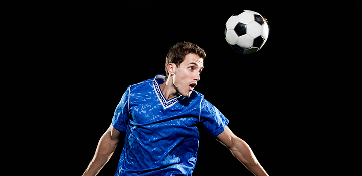 A football player heading the ball.