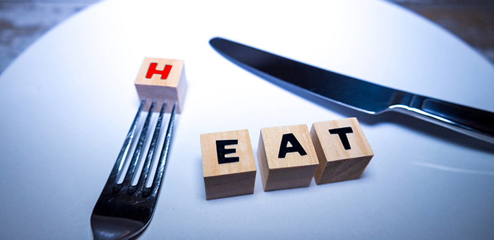 Letters spelling heat, with a knife and fork.