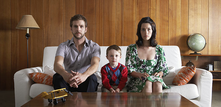 family sitting on sofa