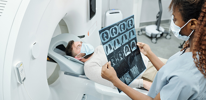 A healthcare professional administers an MRI scan.