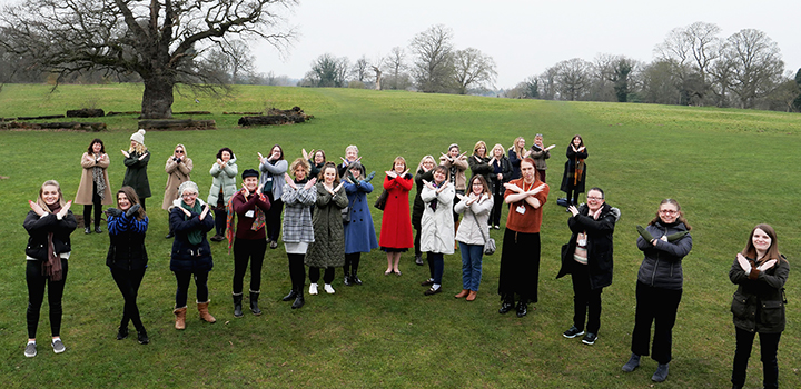 Women at UEA doing the International Women's Day 'Break The Bias' X sign