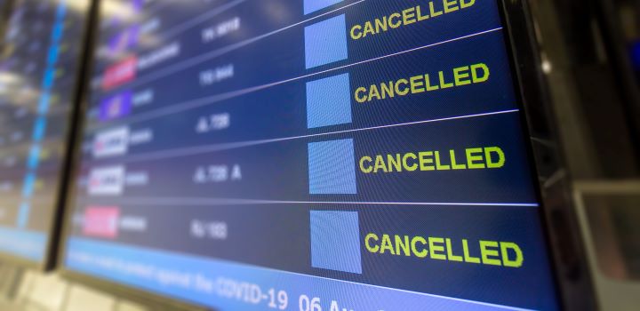 Cancelled flight information board at airport due to COID-19 pandemic