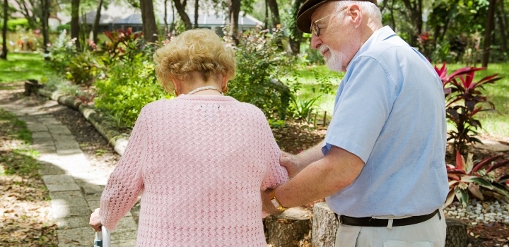 carer with elderly lady in walking frame