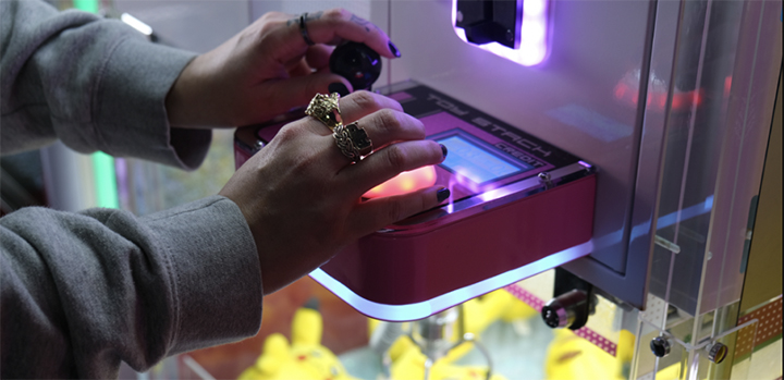 Someone on one of those arcade machines with some Pikachus in the background