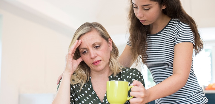 young carer with cup of hot drink