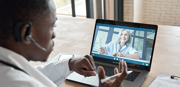 A doctor sees his patient via a video call