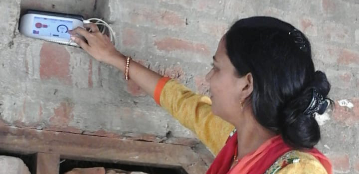 A woman using an air quality measurement device.