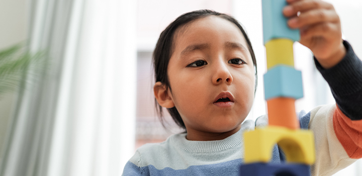 A toddler playing with shapes.