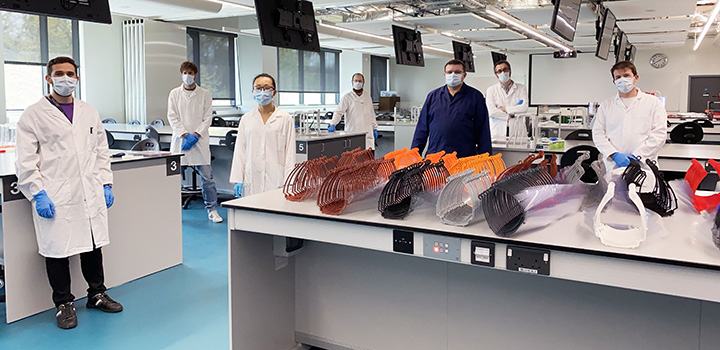 UEA scientists with visors in lab