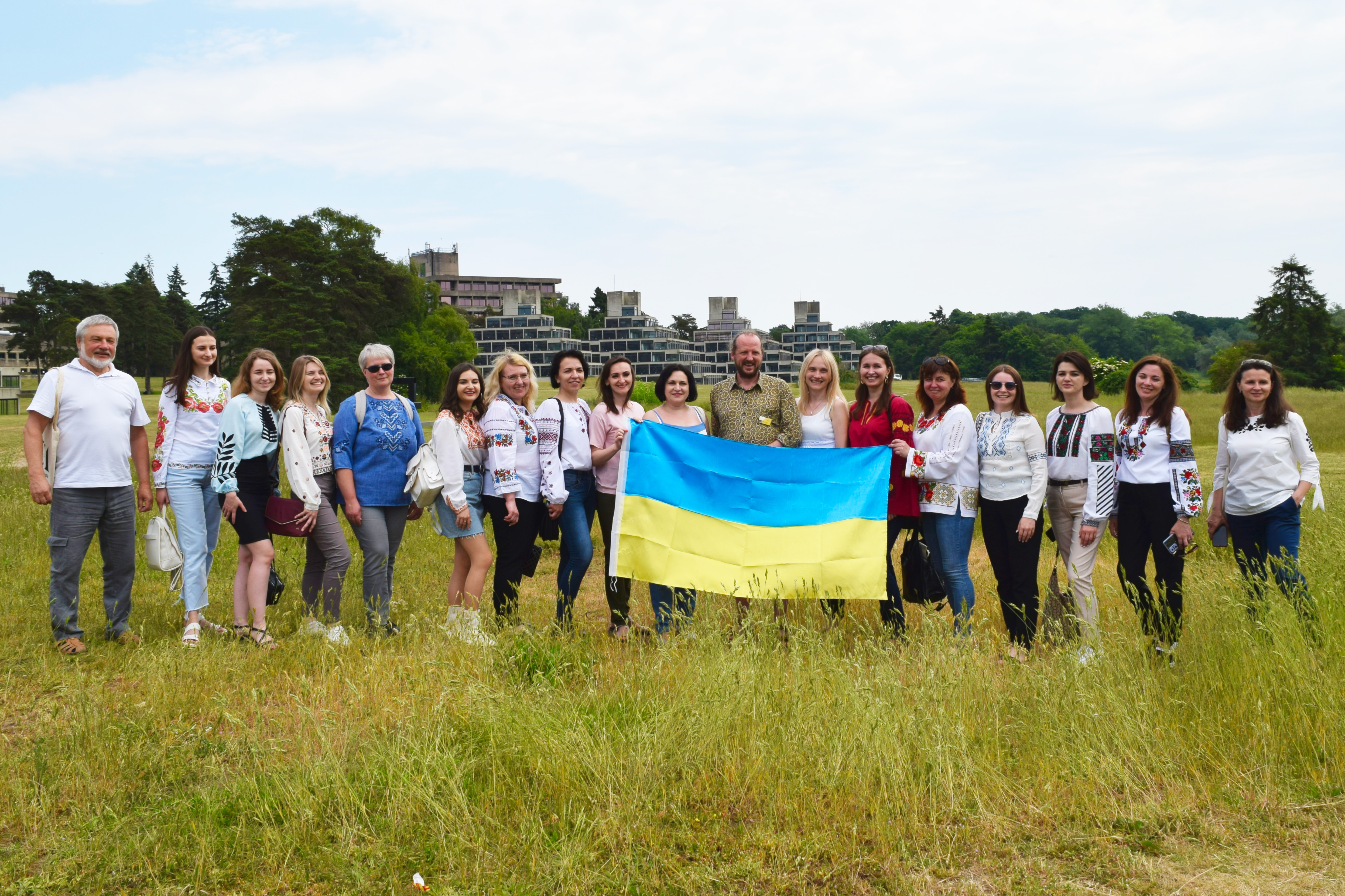PNU academics holding the Ukraine flag, in front of the Ziggurats with UEA staff