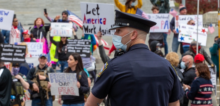 american policeman wearing a face mask at a protest